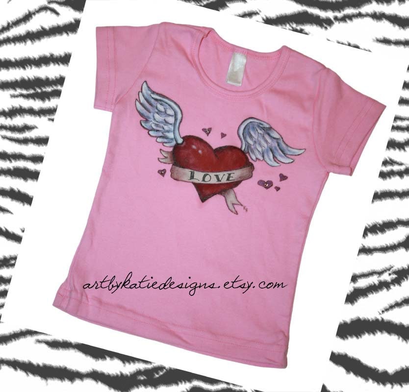 Love heart with angel wings accented with crystal bling on short sleeve pink