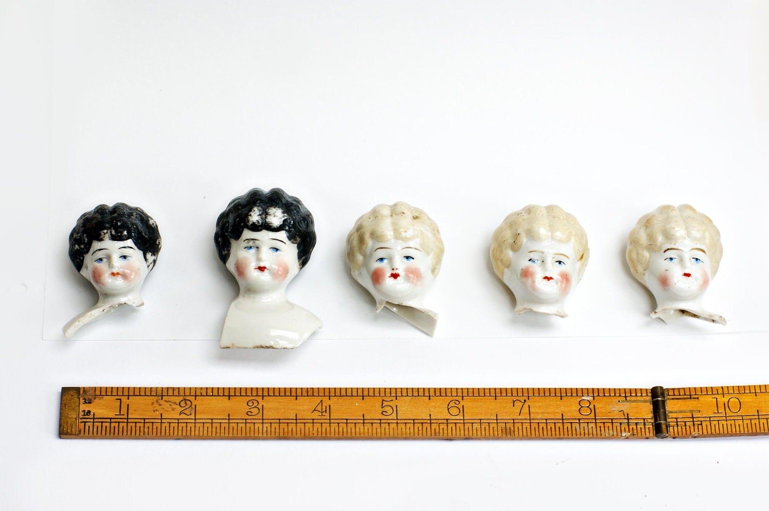 Lot of frozen charlotte bisque porcelain doll heads Doll