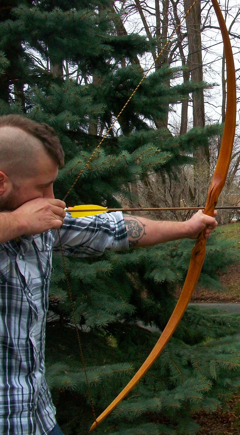 My latest custom carved longbow, built from orange Osage r/Archery